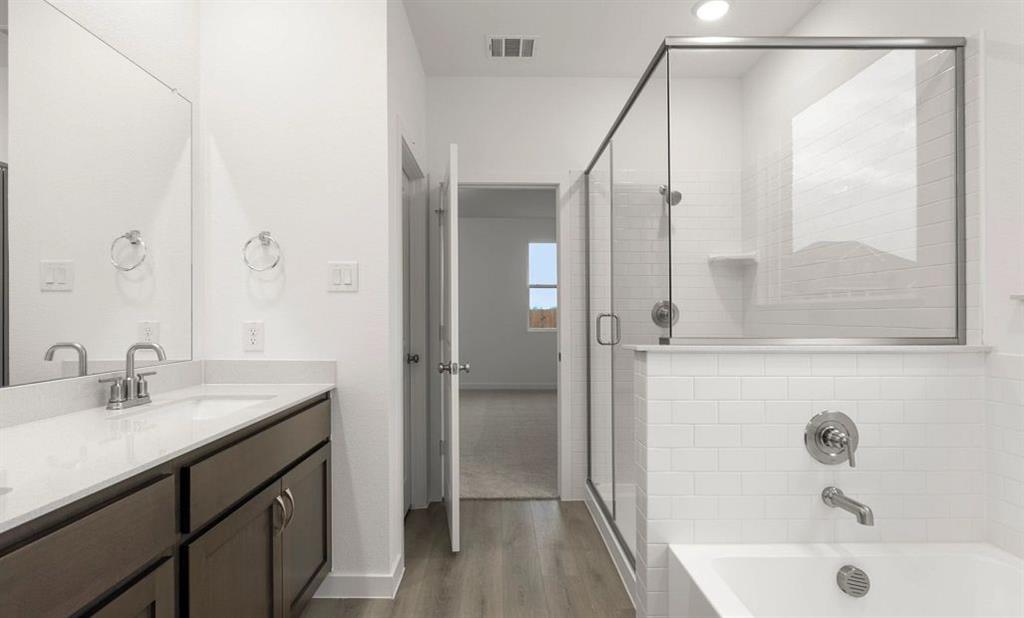 1005 Colgate Circle Princeton, TX 75407 - Photo 37 of 40 a bathroom with a sink and a mirror