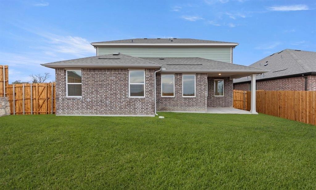 1005 Colgate Circle Princeton, TX 75407 - Photo 10 of 40 a front view of a house with garden