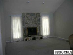 7147 Ramsgate Road Charlotte, NC 28270 - Photo 3 of 8 a living room with a fireplace