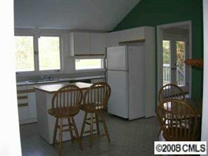 7147 Ramsgate Road Charlotte, NC 28270 - Photo 6 of 8 a kitchen with a refrigerator and a table