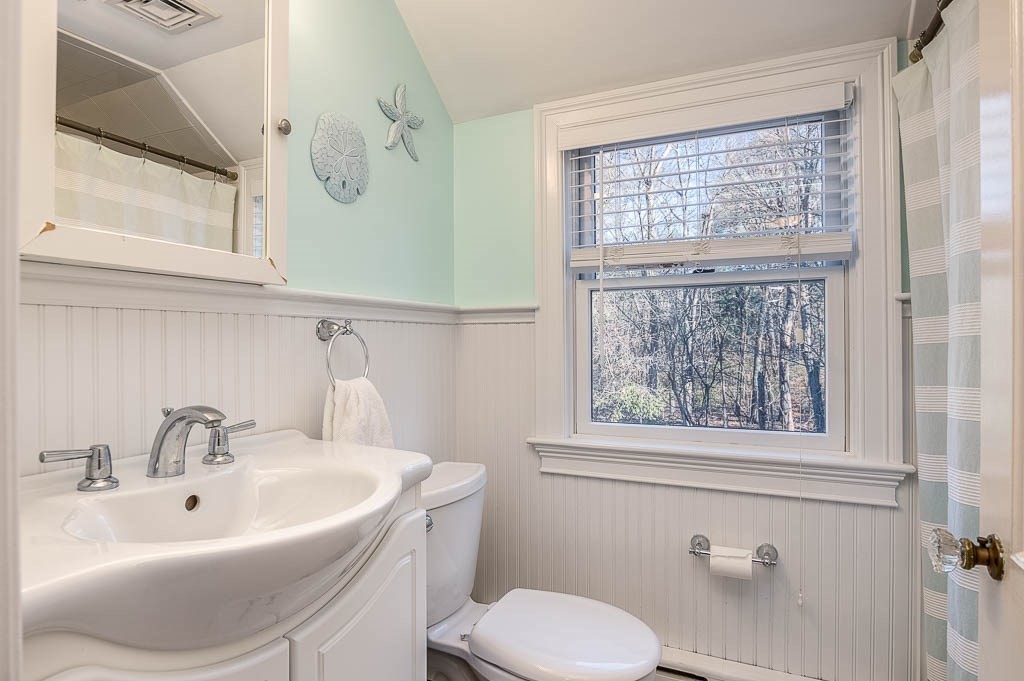 41 Millbrook Road Westwood, MA 02090 - Photo 22 of 42 a bathroom with a sink a toilet and a mirror