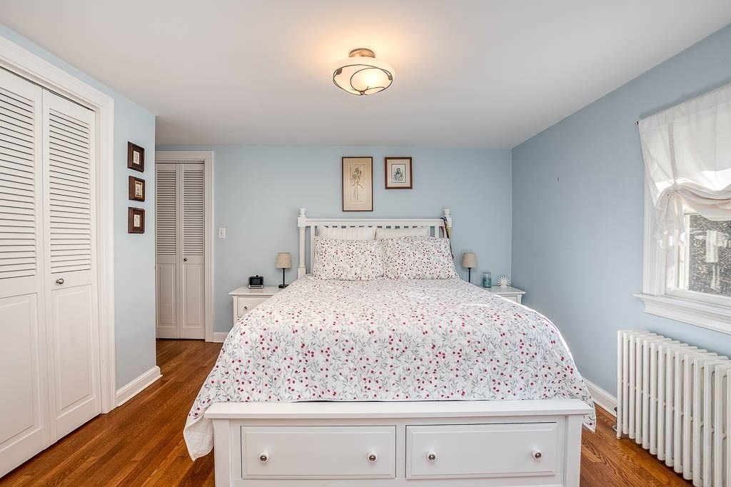 41 Millbrook Road Westwood, MA 02090 - Photo 24 of 42 a bedroom with a bed and wooden floor