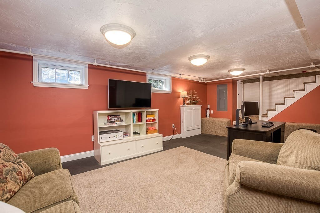 41 Millbrook Road Westwood, MA 02090 - Photo 32 of 42 a living room with furniture and a flat screen tv