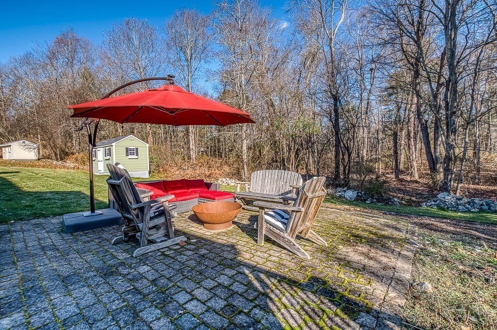 41 Millbrook Road Westwood, MA 02090 - Photo 33 of 42 a backyard of a house with table and chairs