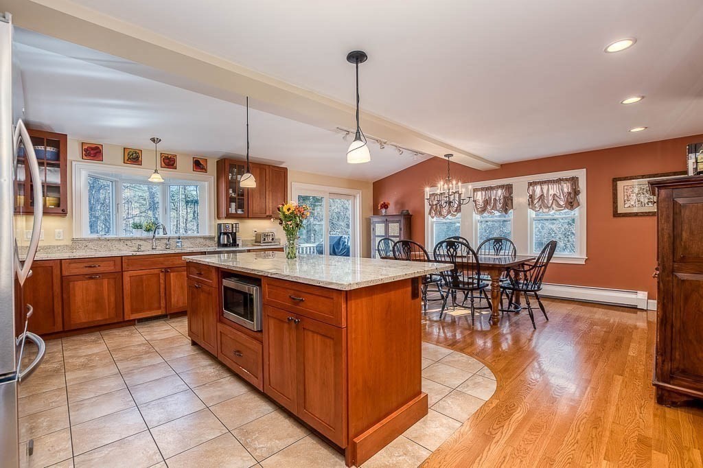 41 Millbrook Road Westwood, MA 02090 - Photo 5 of 42 a kitchen with stainless steel appliances granite countertop a stove and a wooden cabinets