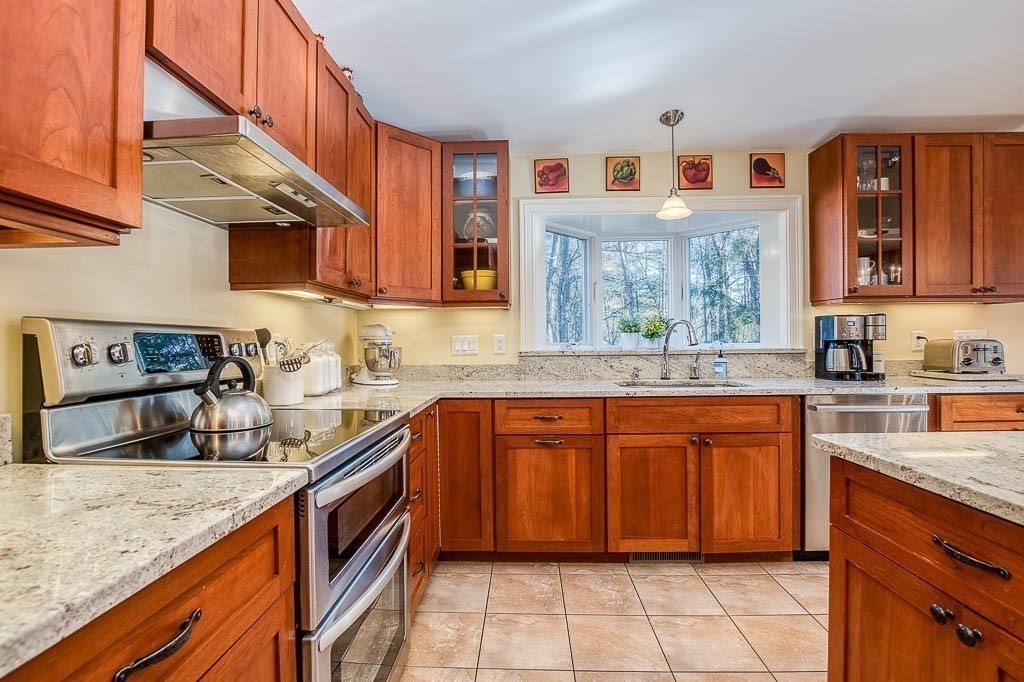 41 Millbrook Road Westwood, MA 02090 - Photo 6 of 42 a kitchen with stainless steel appliances granite countertop a sink stove and cabinets