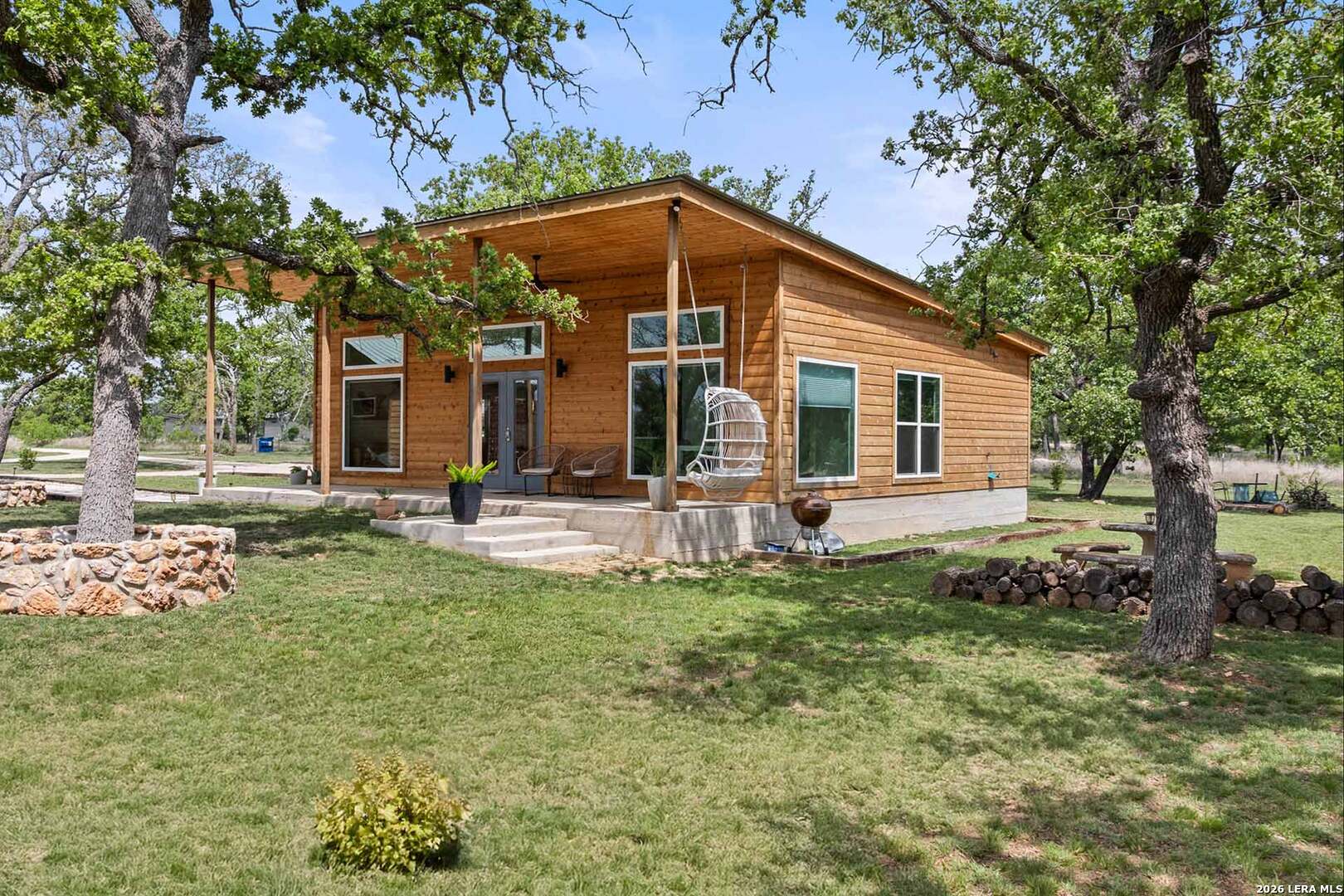 444-742 Klein Road Stonewall, TX 78671 - Photo 33 of 58 a view of a house with backyard and sitting area