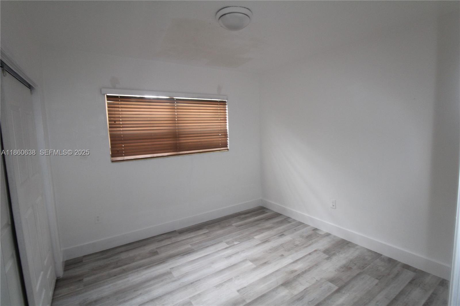965 West 23rd Street Hialeah, FL 33010 - Photo 15 of 16 a view of empty room with wooden floor and fan