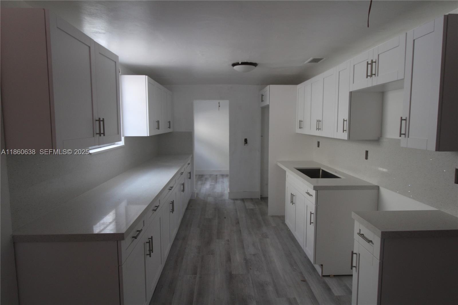 965 West 23rd Street Hialeah, FL 33010 - Photo 4 of 16 a kitchen with granite countertop a sink a stove and refrigerator