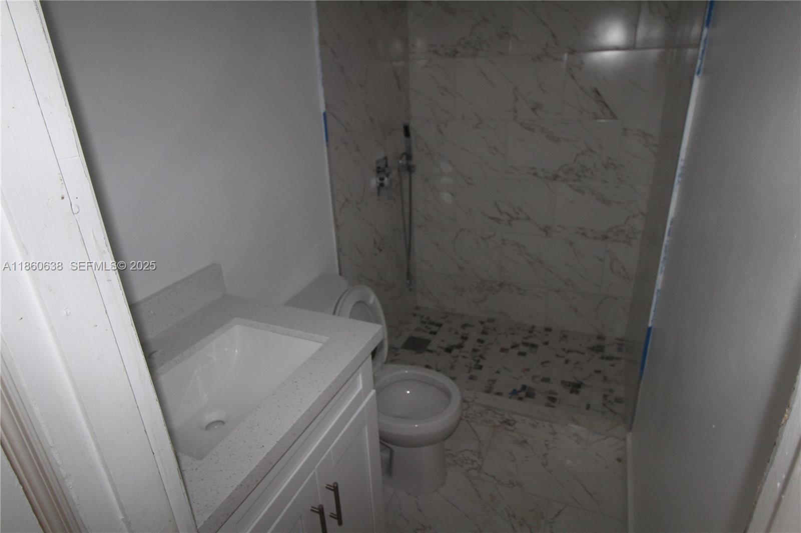 965 West 23rd Street Hialeah, FL 33010 - Photo 5 of 16 a bathroom with a sink a toilet and shower