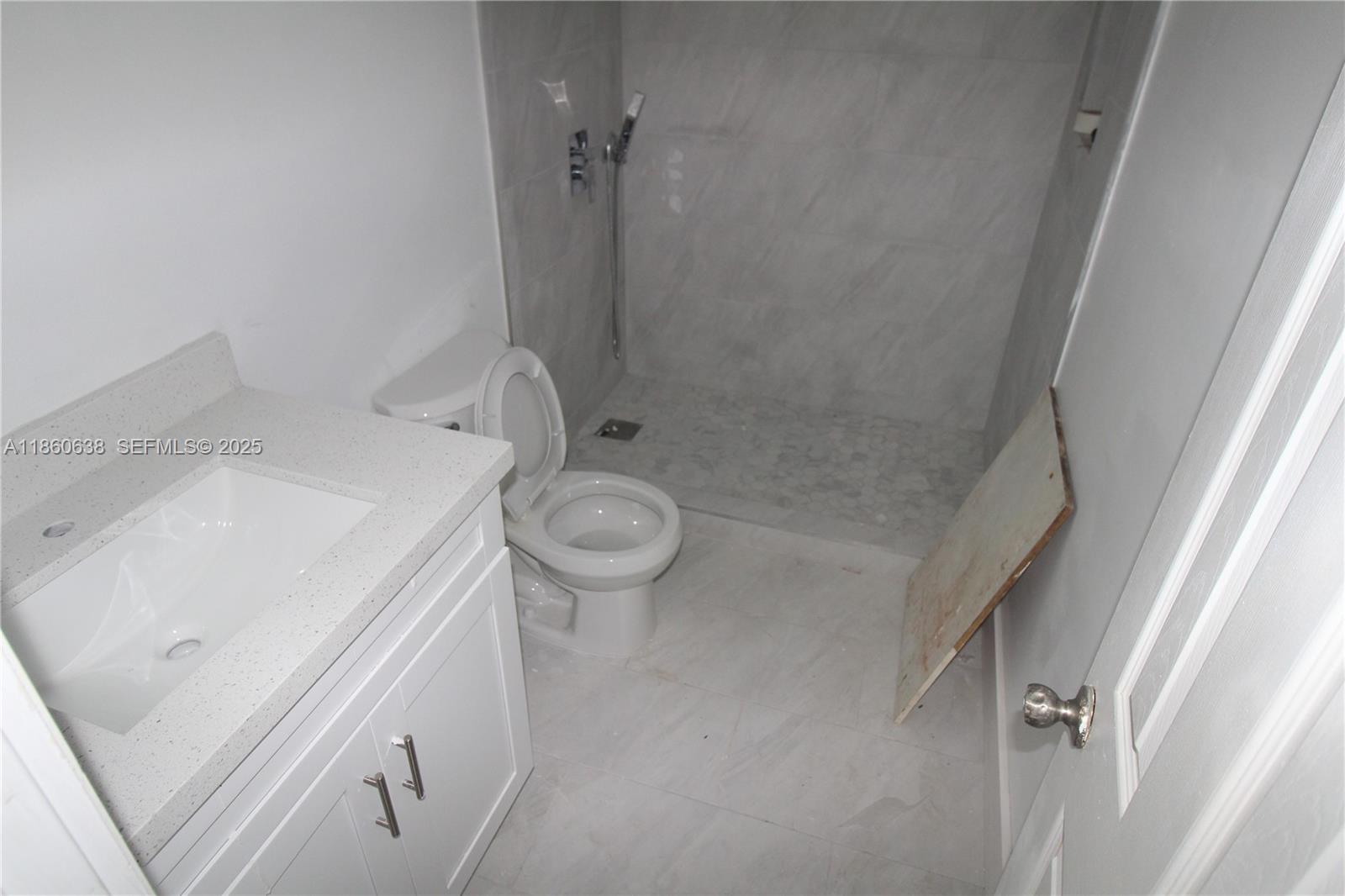 965 West 23rd Street Hialeah, FL 33010 - Photo 6 of 16 a bathroom with a sink a toilet and shower
