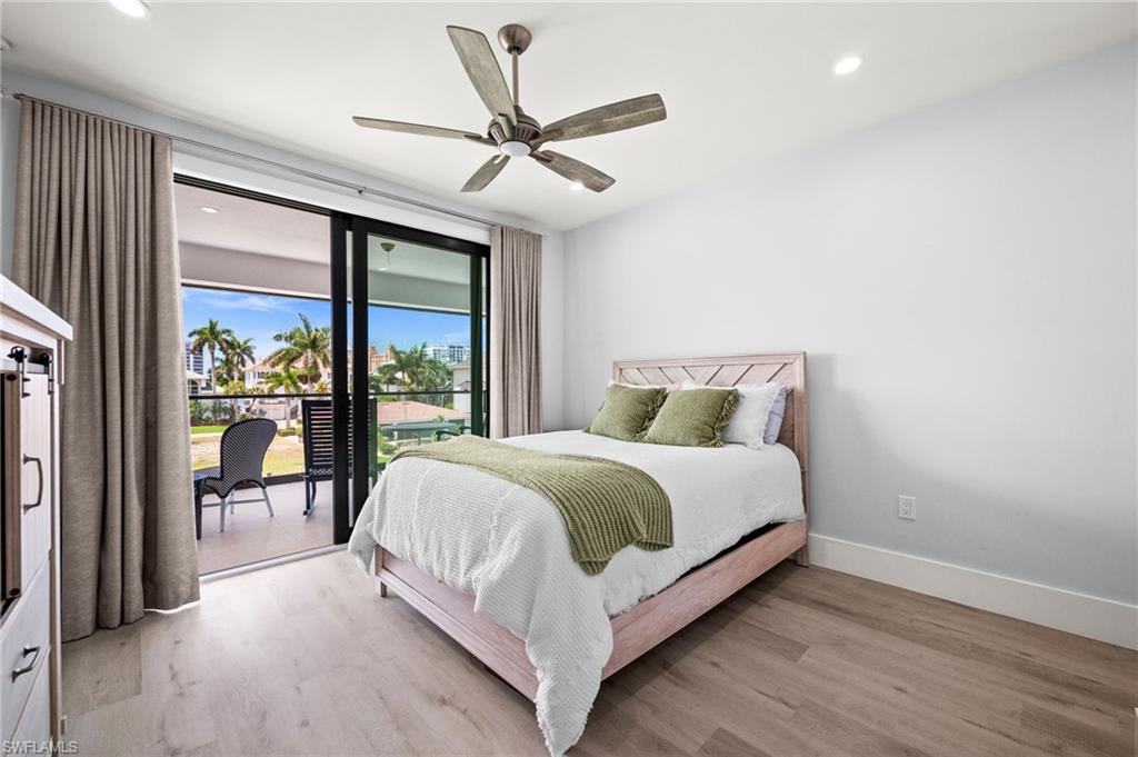 388 Pine Avenue Naples, FL 34108 - Photo 28 of 34 a bed sitting in a spacious bedroom next to a large window
