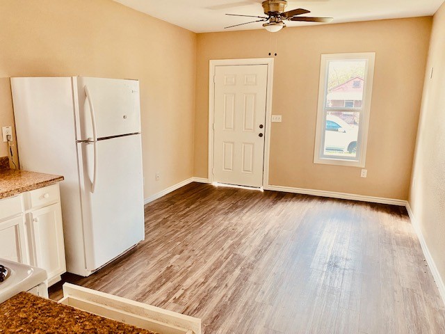 7409 Avenue L, Unit C Houston, TX 77011 - Photo 7 of 11 a view of an empty room with a window and wooden floor