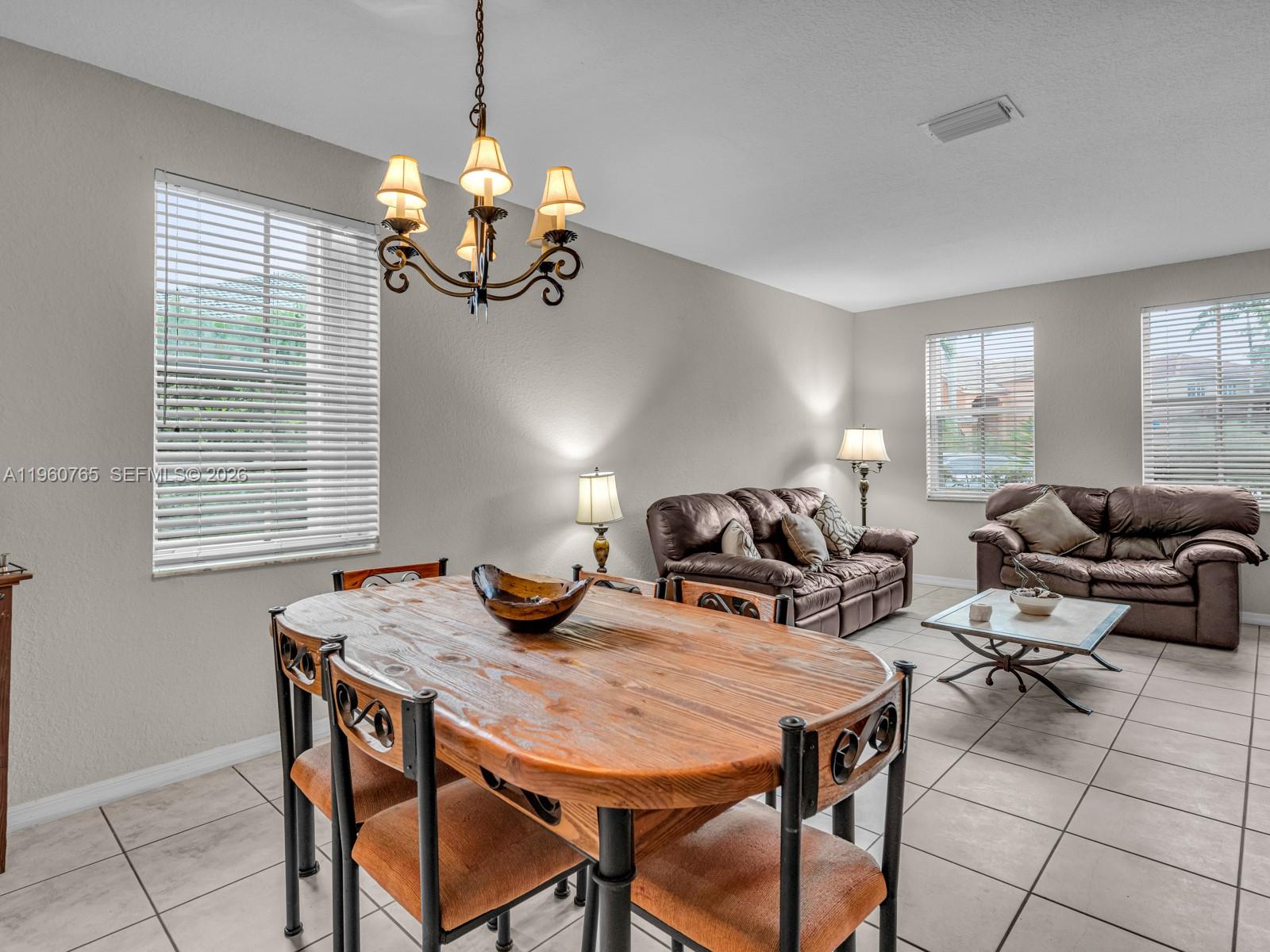 4209 Pinewood Lane Weston, FL 33331 - Photo 14 of 85 a view of a dining room and livingroom with furniture wooden floor and a chandelier