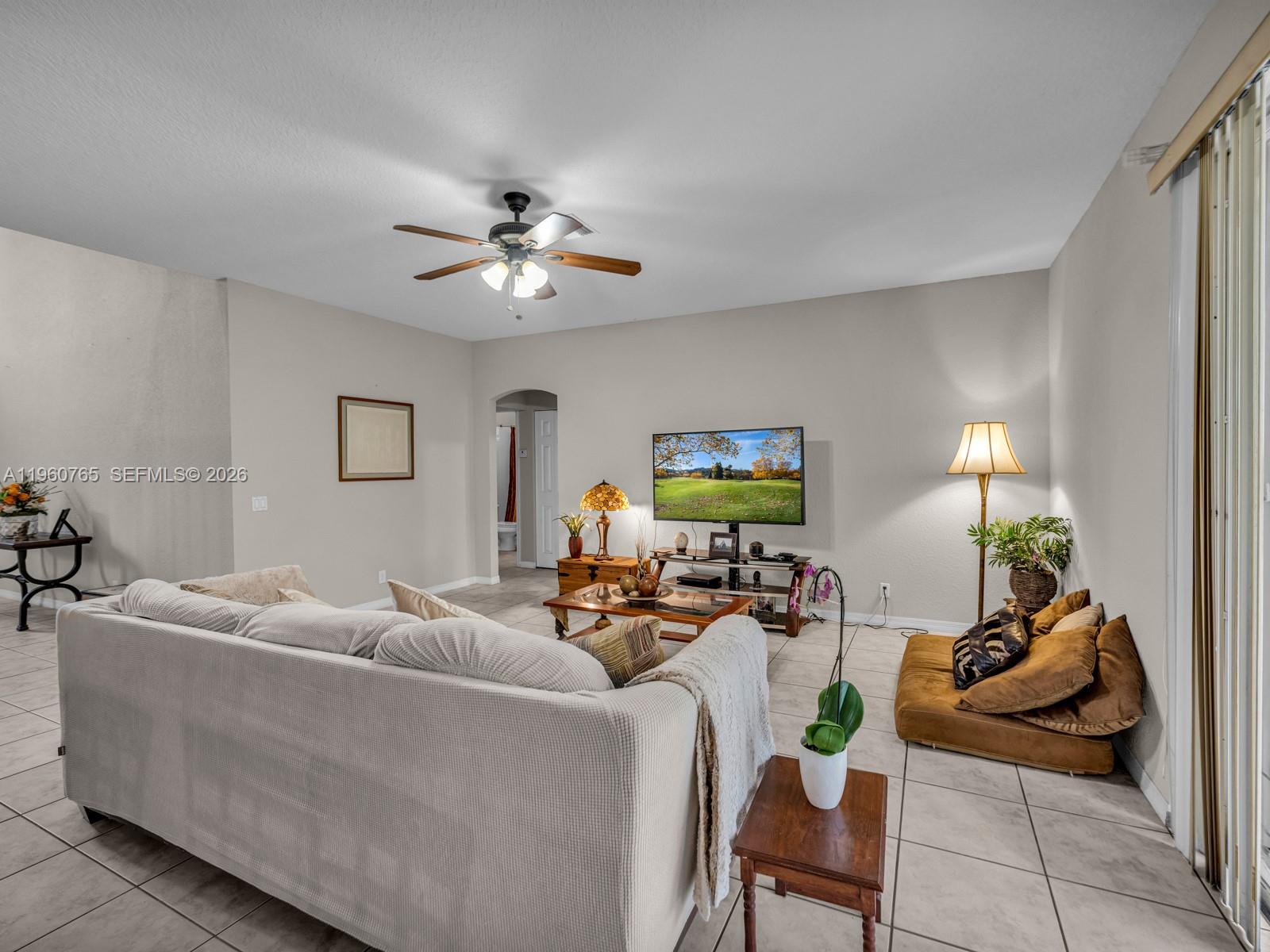 4209 Pinewood Lane Weston, FL 33331 - Photo 19 of 85 a living room with furniture a chandelier and a potted plant