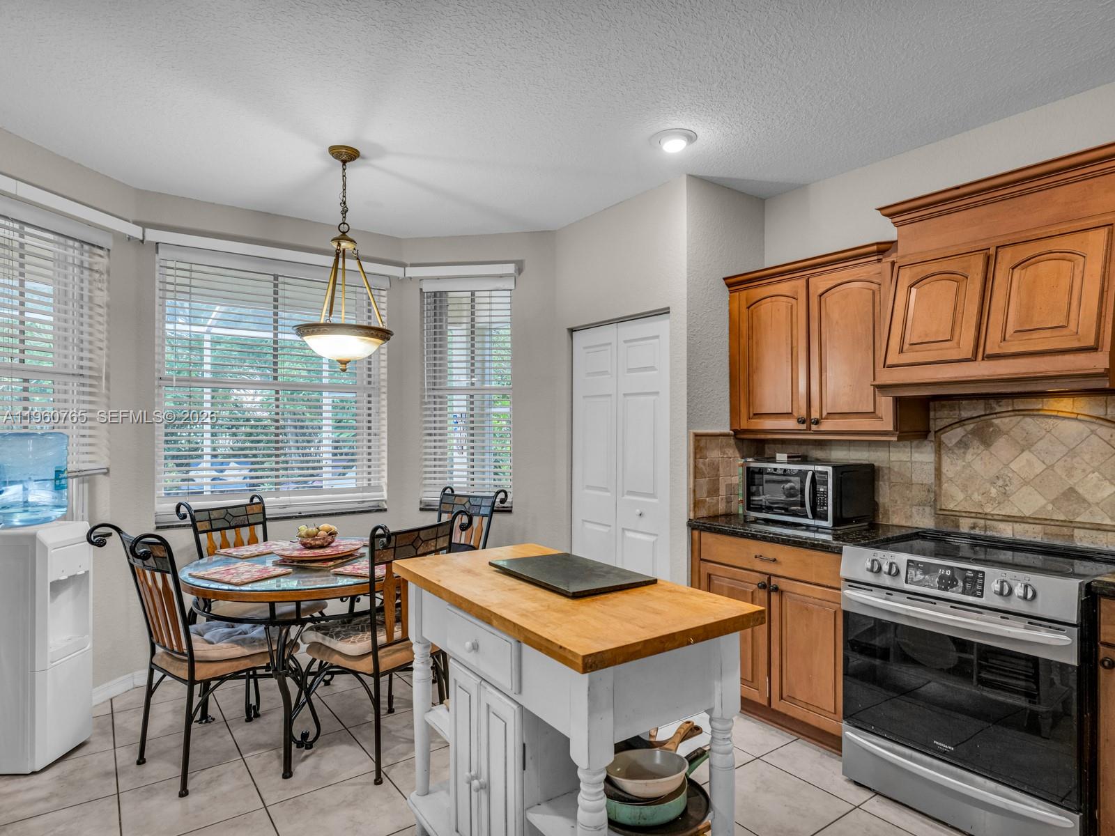 4209 Pinewood Lane Weston, FL 33331 - Photo 23 of 85 a kitchen with a stove a sink and a refrigerator