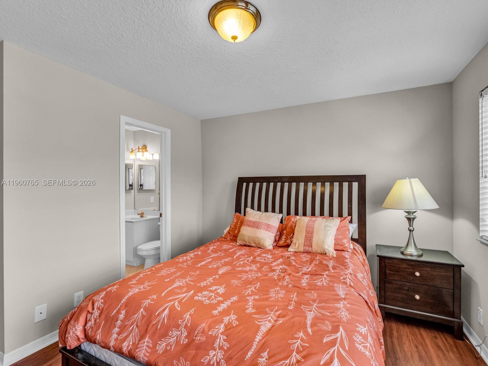 4209 Pinewood Lane Weston, FL 33331 - Photo 29 of 85 a bedroom with a bed and a lamp