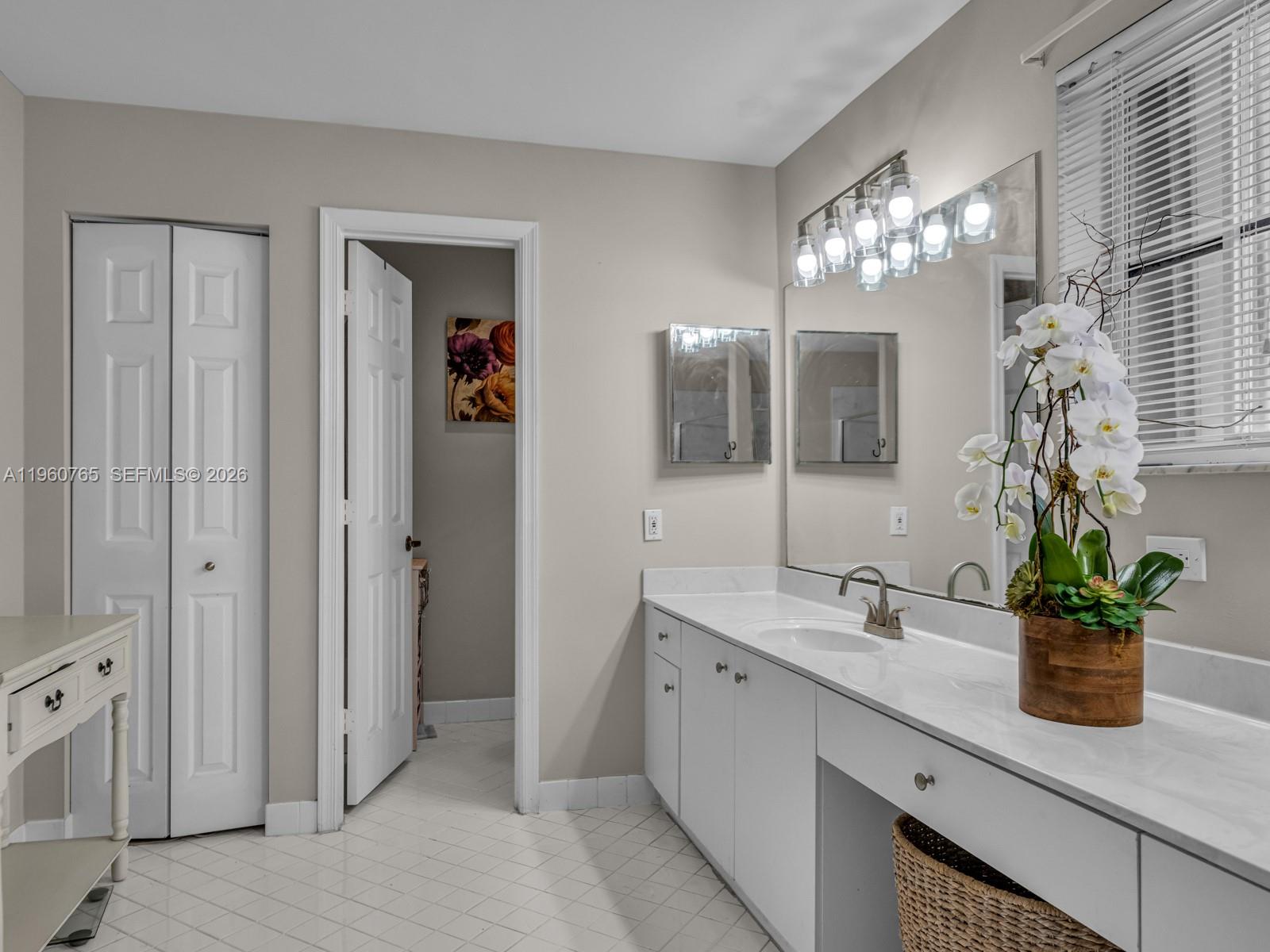 4209 Pinewood Lane Weston, FL 33331 - Photo 37 of 85 a bathroom with a sink a potted plant and a mirror