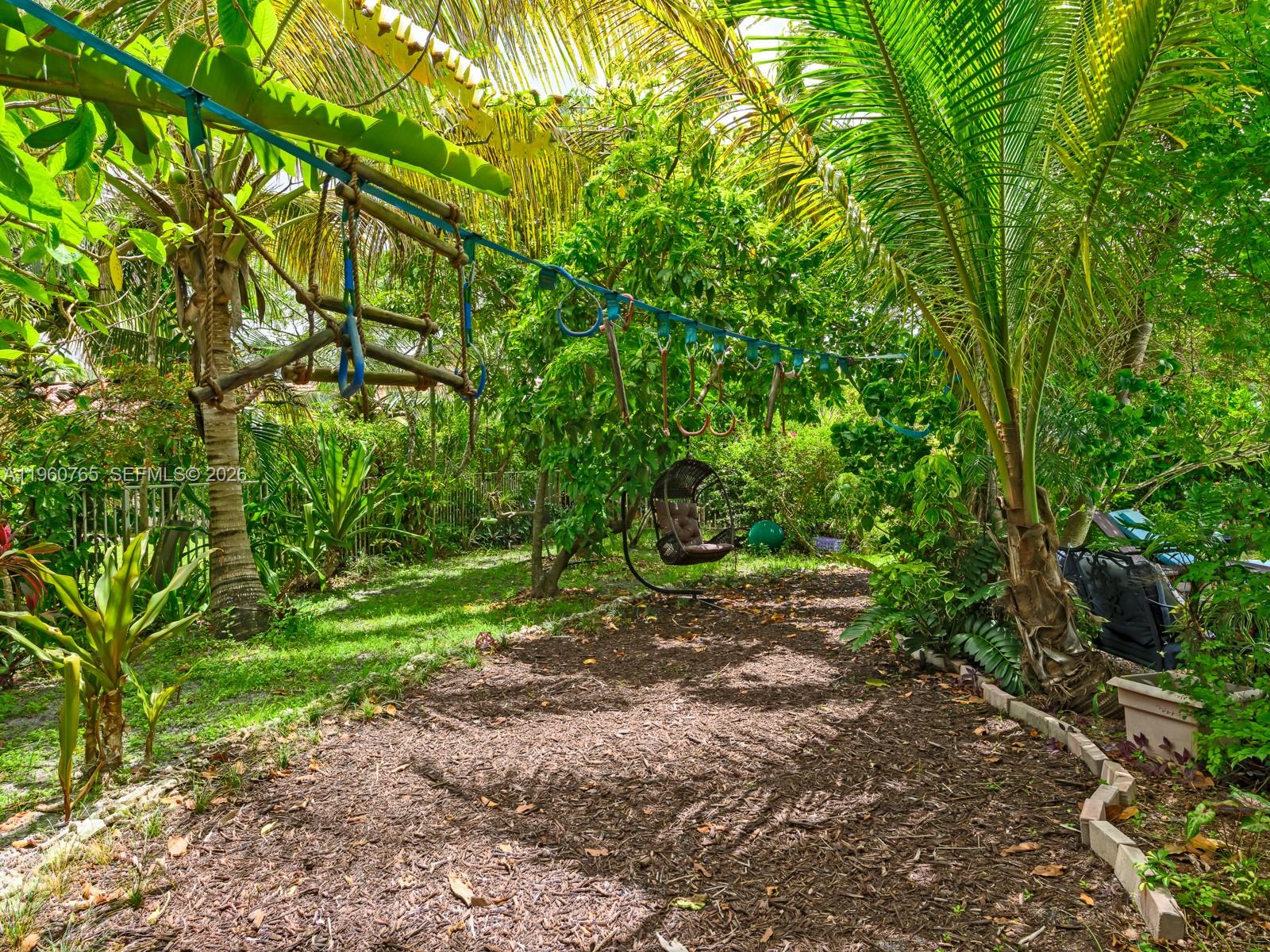 4209 Pinewood Lane Weston, FL 33331 - Photo 53 of 85 a backyard of a house with lots of green space