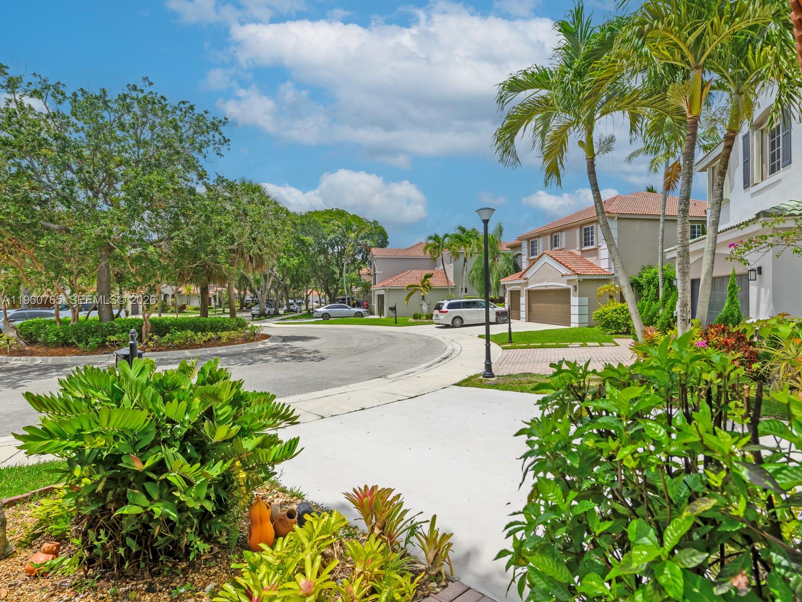 4209 Pinewood Lane Weston, FL 33331 - Photo 8 of 85 a view of a street with houses on both side