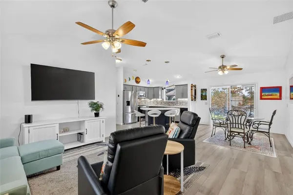 a view of a livingroom with furniture and a flat screen tv