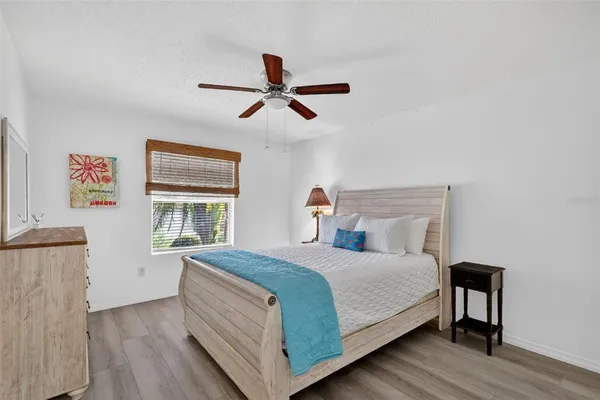 a bedroom with a bed and a chandelier