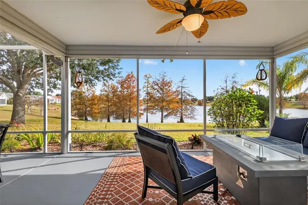 a view of a patio with a table and chairs under an umbrella