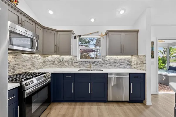 a kitchen with stainless steel appliances granite countertop a stove and a sink
