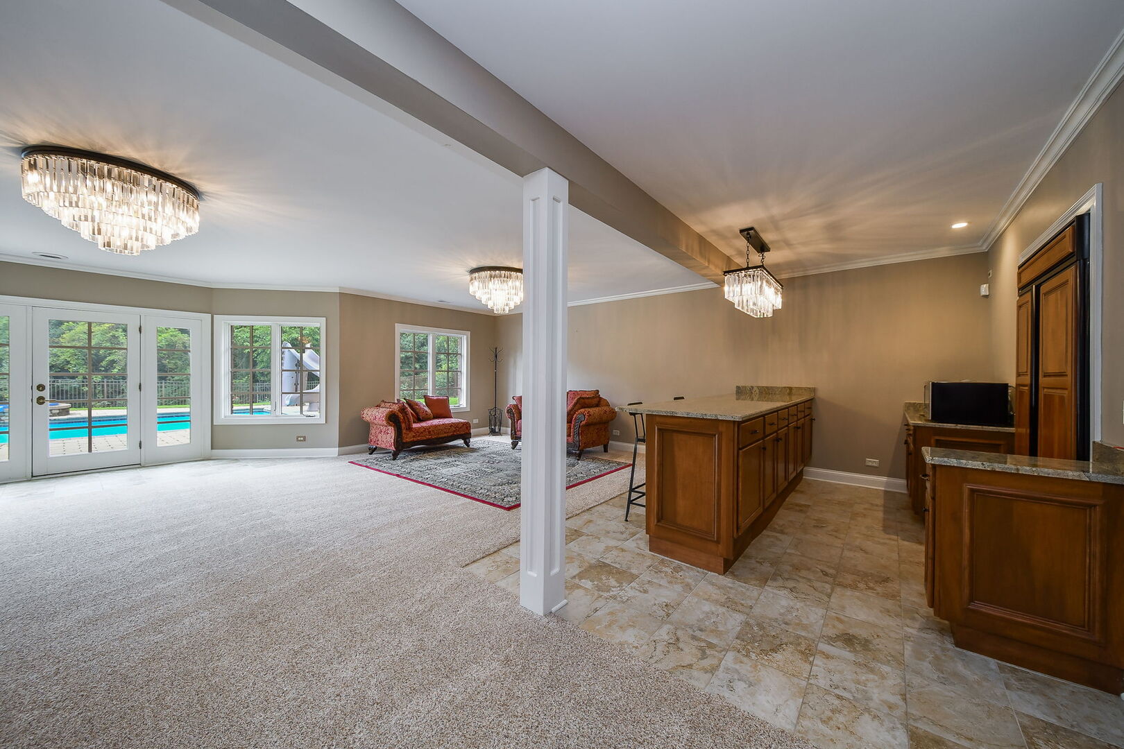 34W791 Army Trail Road Wayne, IL 60174 - Photo 46 of 65 a view of a livingroom with furniture a fireplace a ceiling fan and windows