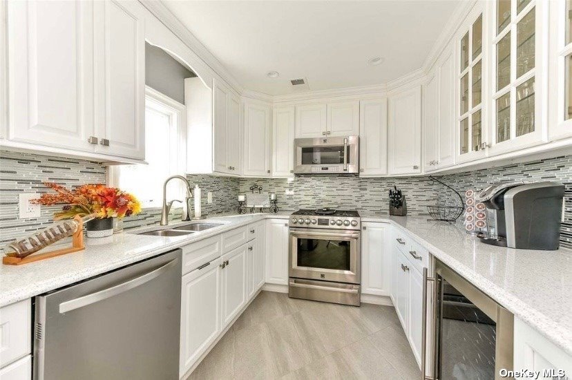 425 Emory Road Mineola, NY 11501 - Photo 1 of 1 a kitchen with stainless steel appliances granite countertop a sink stove and cabinets