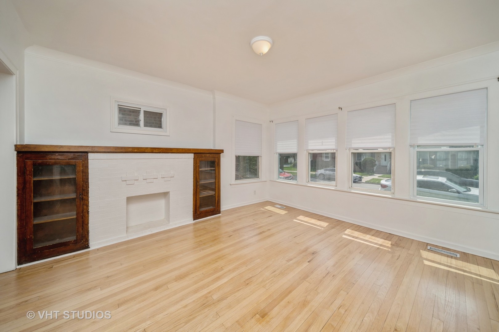 552 East 91st Place Chicago, IL 60619 - Photo 2 of 17 a view of an empty room with a fireplace and a window