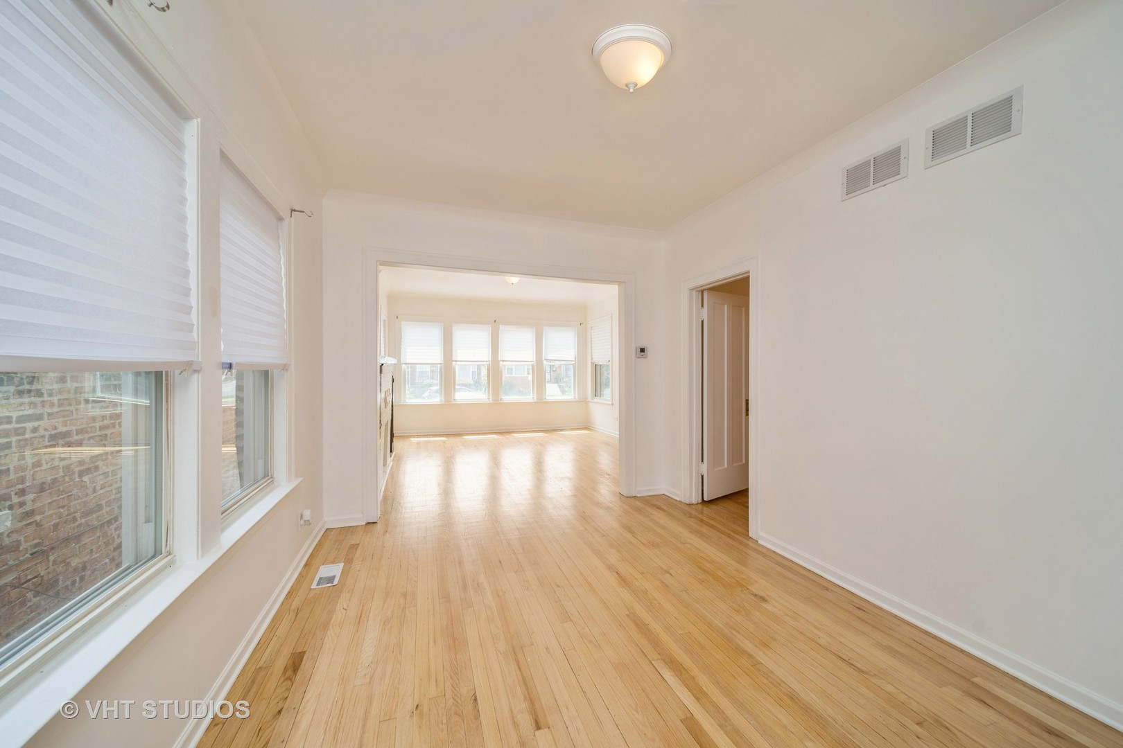 552 East 91st Place Chicago, IL 60619 - Photo 3 of 17 a view of an empty room with wooden floor and a window