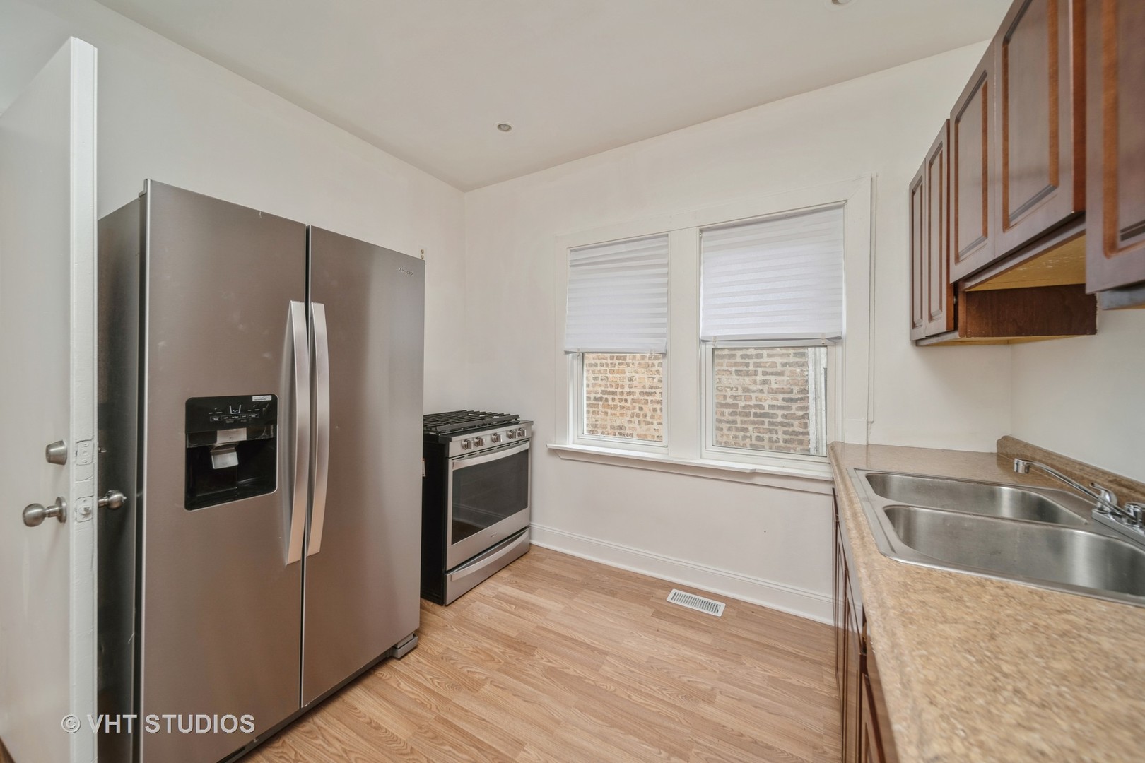 552 East 91st Place Chicago, IL 60619 - Photo 4 of 17 a kitchen with stainless steel appliances granite countertop a refrigerator and a sink