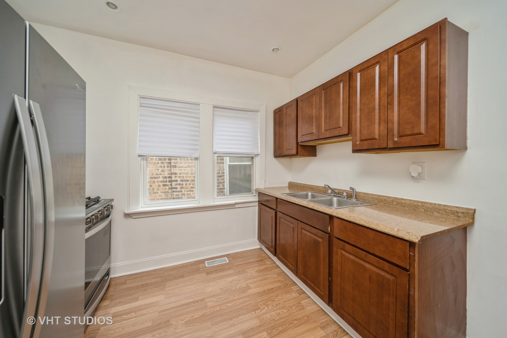 552 East 91st Place Chicago, IL 60619 - Photo 5 of 17 a kitchen with granite countertop a refrigerator sink and cabinets