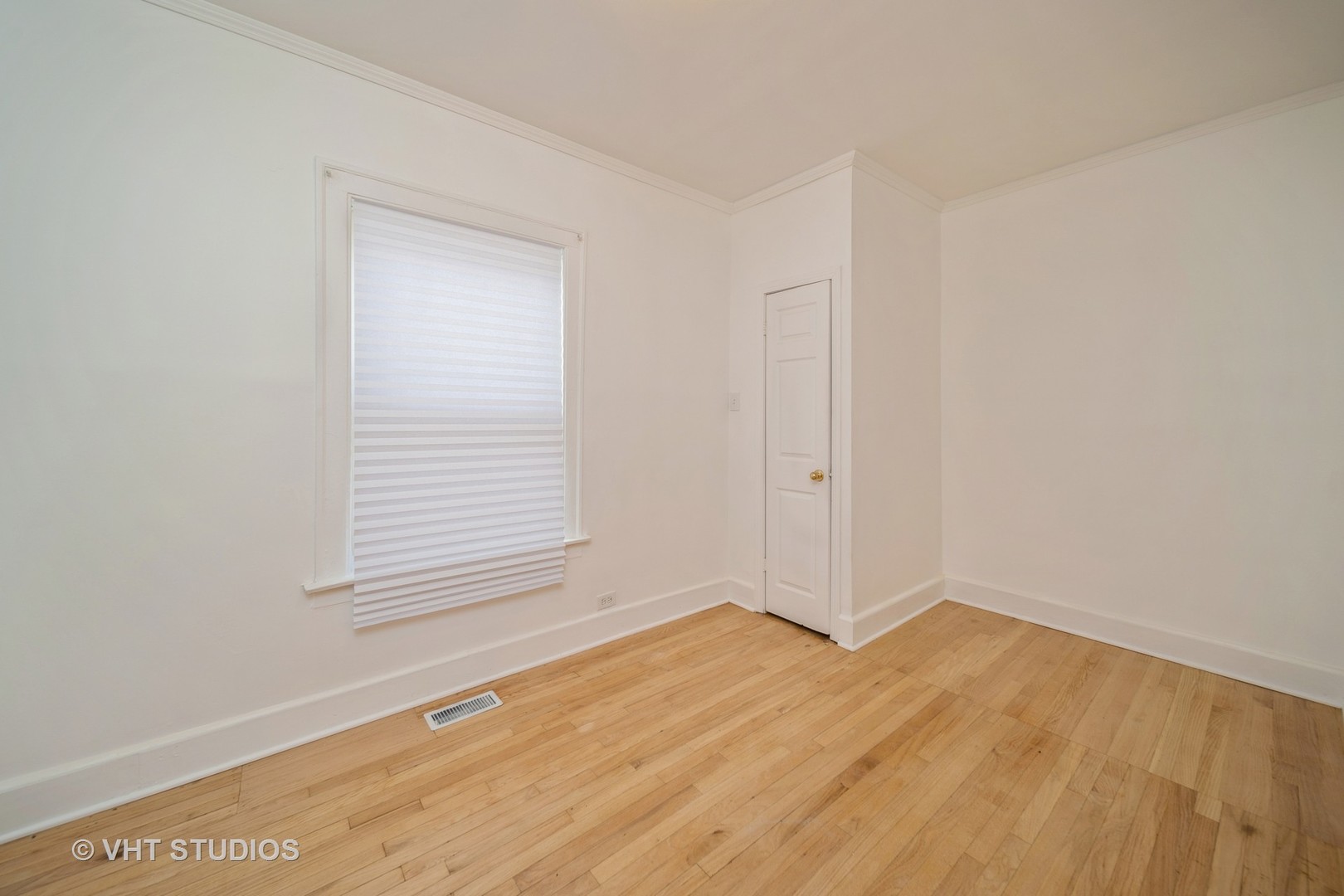 552 East 91st Place Chicago, IL 60619 - Photo 8 of 17 a view of an empty room with wooden floor and a window