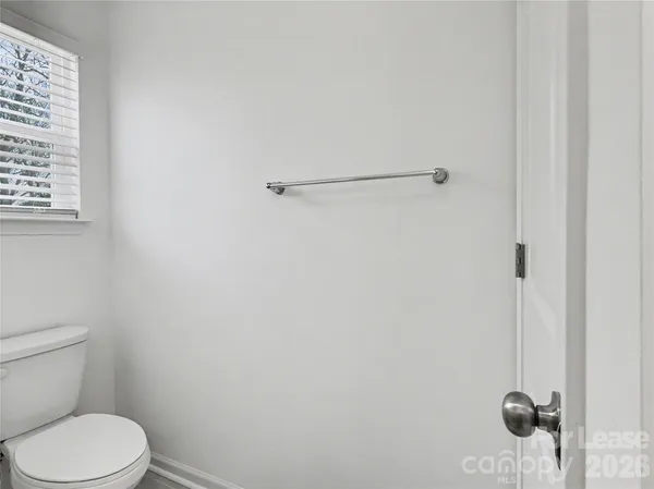 a white toilet sitting next to a shower