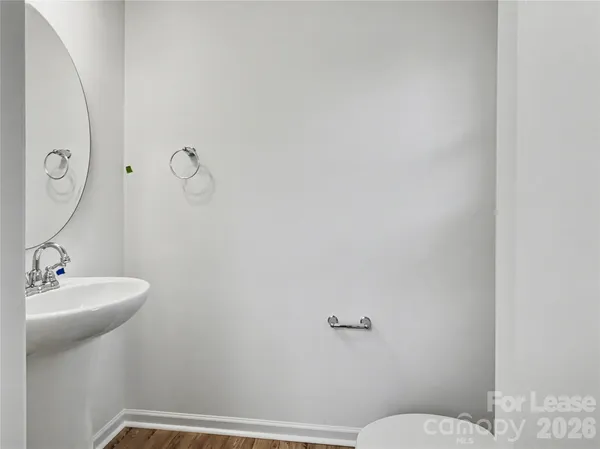 a bathroom with a sink mirror and toilet