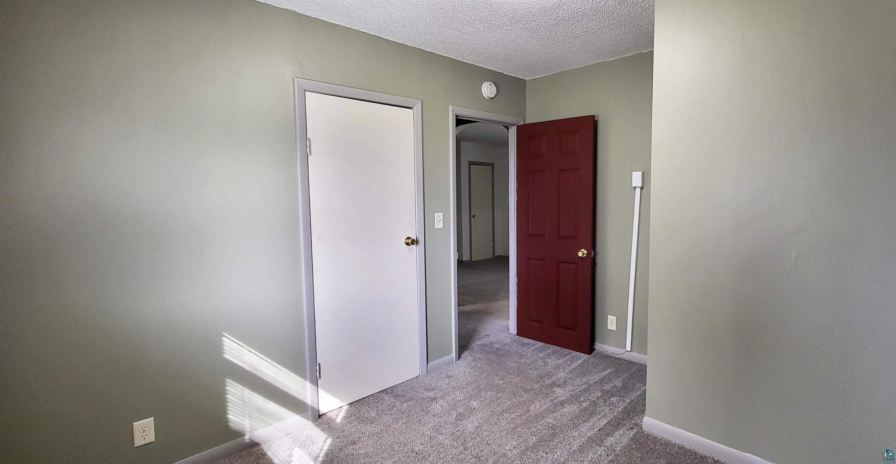 56 East 2nd Street Superior, WI 54880 - Photo 14 of 18 Room with light green walls and light gray patterned carpet