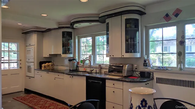 a view of hall way with furniture and floor to ceiling window