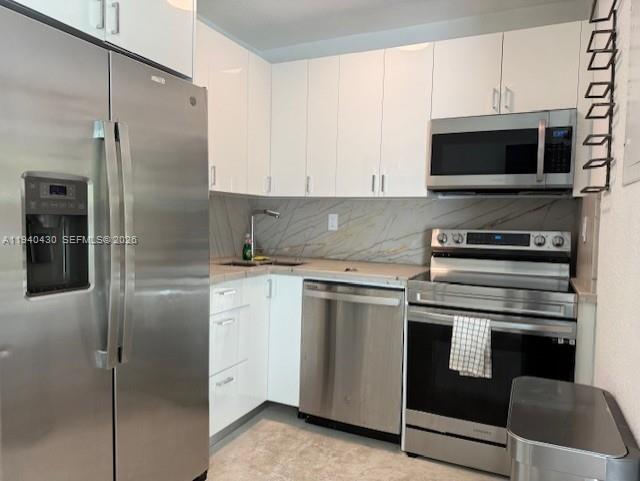 150 Southwest 10th Street, Unit 7 Miami, FL 33130 - Photo 12 of 15 a kitchen with stainless steel appliances kitchen island granite countertop a refrigerator stove and microwave