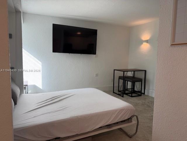 150 Southwest 10th Street, Unit 7 Miami, FL 33130 - Photo 5 of 15 a bedroom with a bed and a flat screen tv