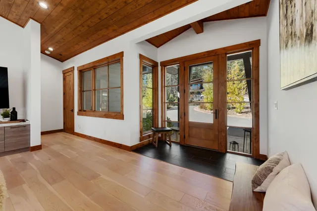 a view of a livingroom with furniture and floor to ceiling window