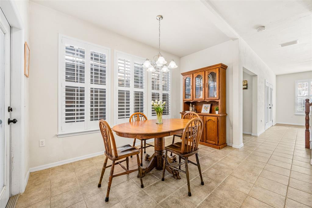 11550 Northwest 17 Place Gainesville, FL 32606 - Photo 15 of 48 a dining room with furniture and window