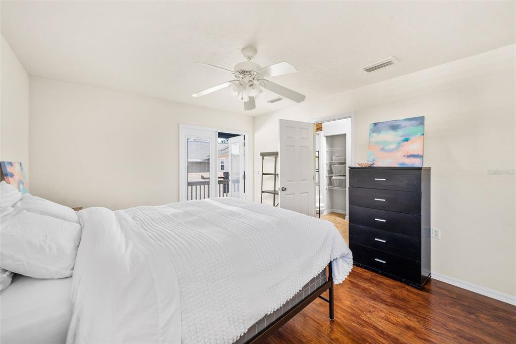 11550 Northwest 17 Place Gainesville, FL 32606 - Photo 28 of 48 a bedroom with a bed a lamp and a chandelier