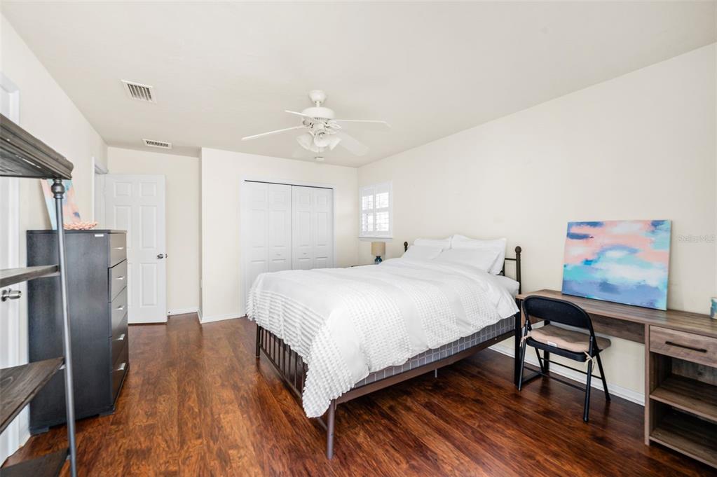 11550 Northwest 17 Place Gainesville, FL 32606 - Photo 29 of 48 a spacious bedroom with a bed and a chandelier