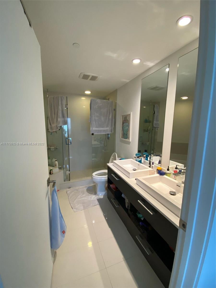 Brickell Heights II Miami, FL 33130 - Photo 6 of 12 a bathroom with a double vanity sink and mirror