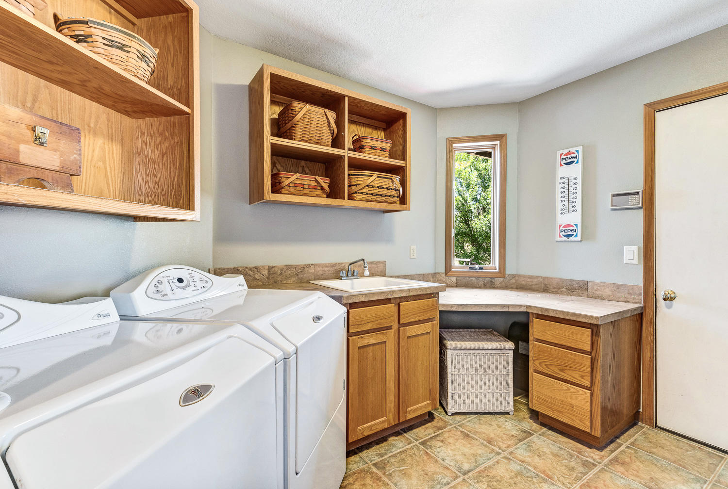 19310 Dayton Road Bend, OR 97703 - Photo 19 of 40 Huge laundry/mud room with ample cabinets and shelves and laundry sink has access to garage.