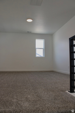 2613 Scarlet Road, Unit 258 Eagle Mountain, UT 84005 - Photo 21 of 32 Carpeted room featuring a single window, white walls, and a ceiling-mounted light fixture