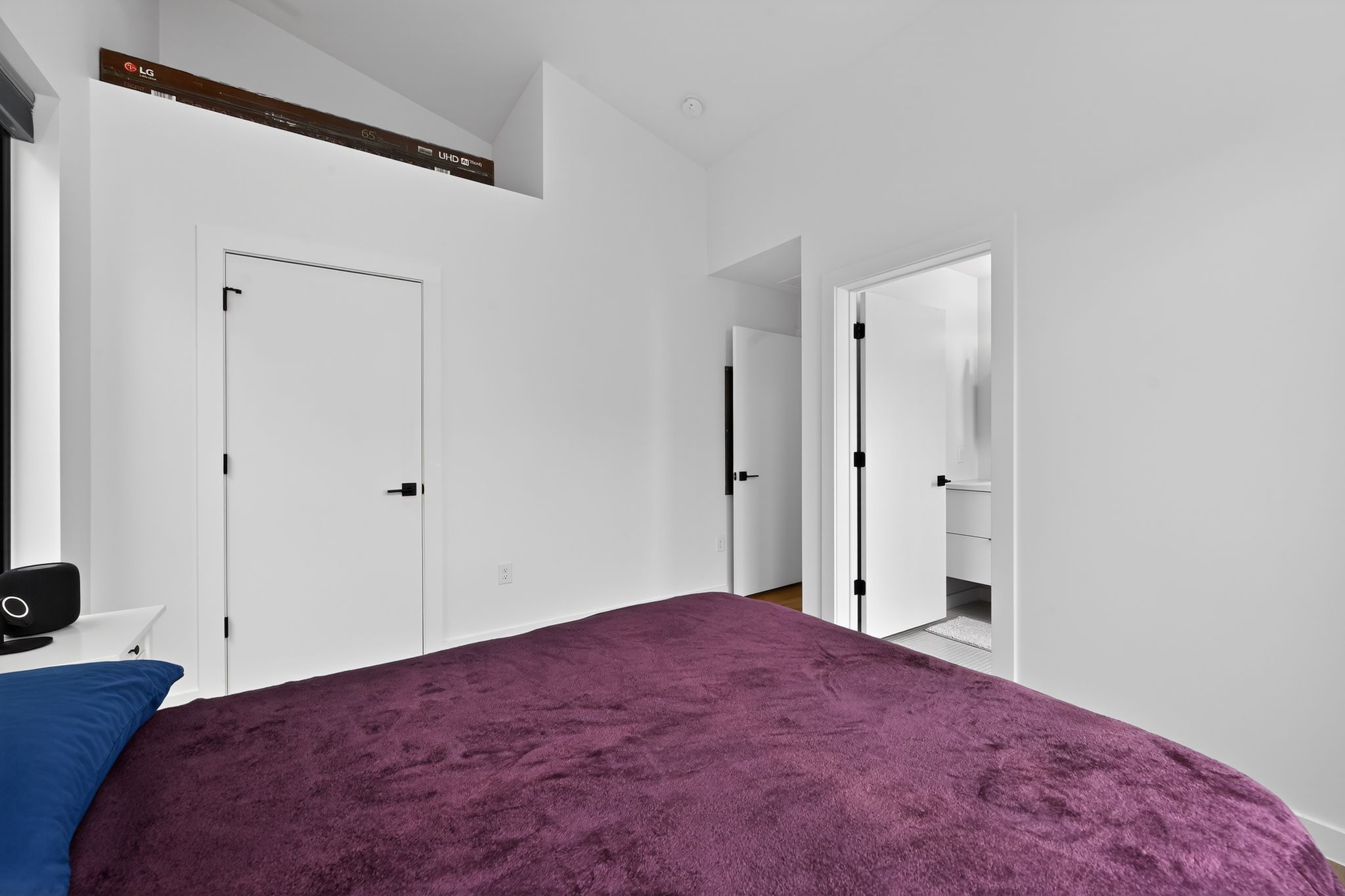 1206 Luna Street, Unit 2 Austin, TX 78721 - Photo 21 of 30 Bedroom featuring white walls and doors with black hardware