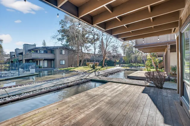 an aerial view of a house with swimming pool and sitting area
